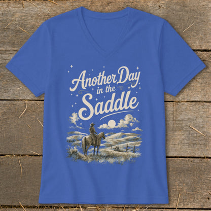 Royal blue t-shirt with "Another Day in the Saddle" text and cowboy on horseback scene.