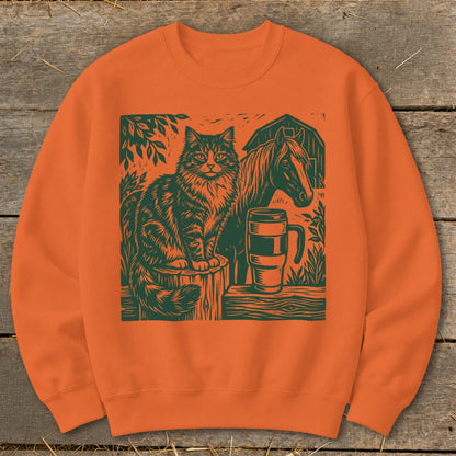 Fluffy cat sits on a barrel next to a horse and a mug with a barn in the background.