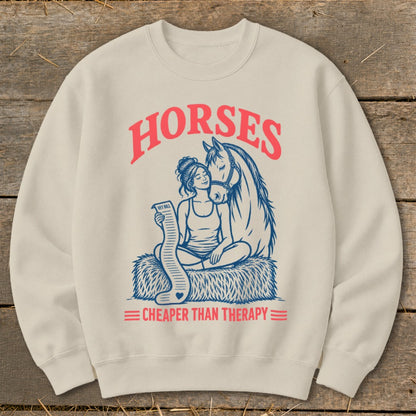 Cream sweatshirt with "Horses" and "Cheaper Than Therapy" text and horse and woman graphic.