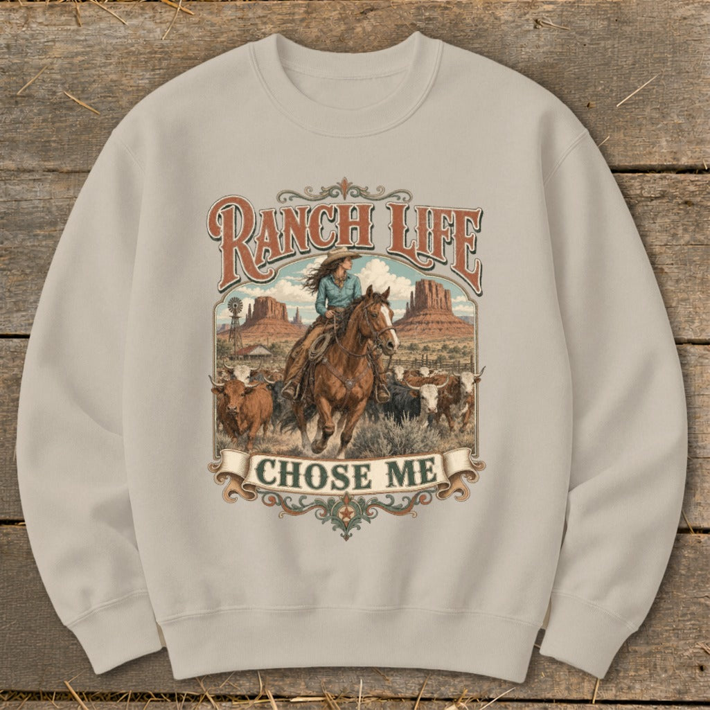 Graphic on sweatshirt features a woman on horseback herding cattle with "Ranch Life Chose Me" text.