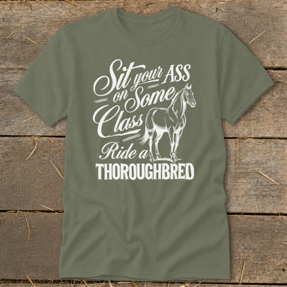 Olive green t-shirt with white text and a horse graphic reading "Sit your ASS on Some Class Ride a THOROUGHBRED".