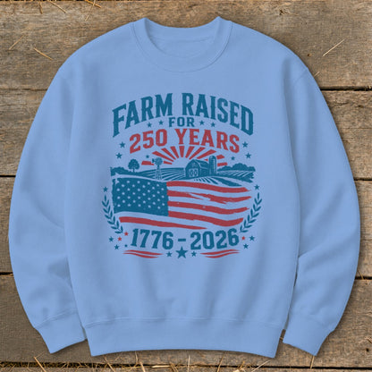 Light blue sweatshirt with graphic: Farm Raised for 250 Years, 1776-2026.