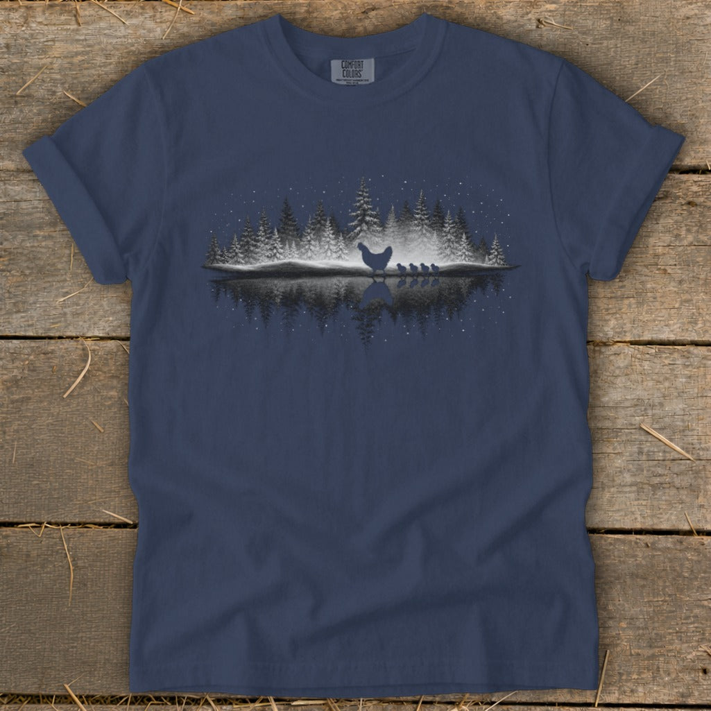 Dark blue t-shirt with a silhouette of a hen and chicks in a winter forest scene.