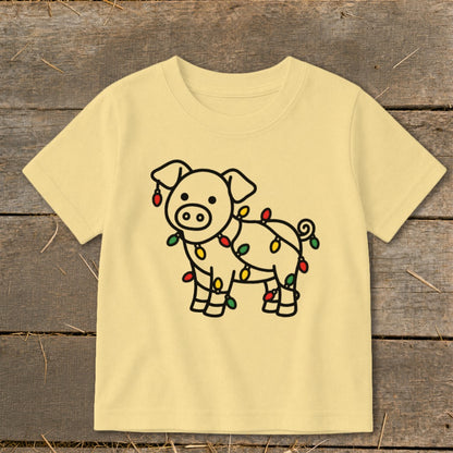 Light yellow short-sleeved children's t-shirt featuring a black outline graphic of a pig wrapped in Christmas lights.
