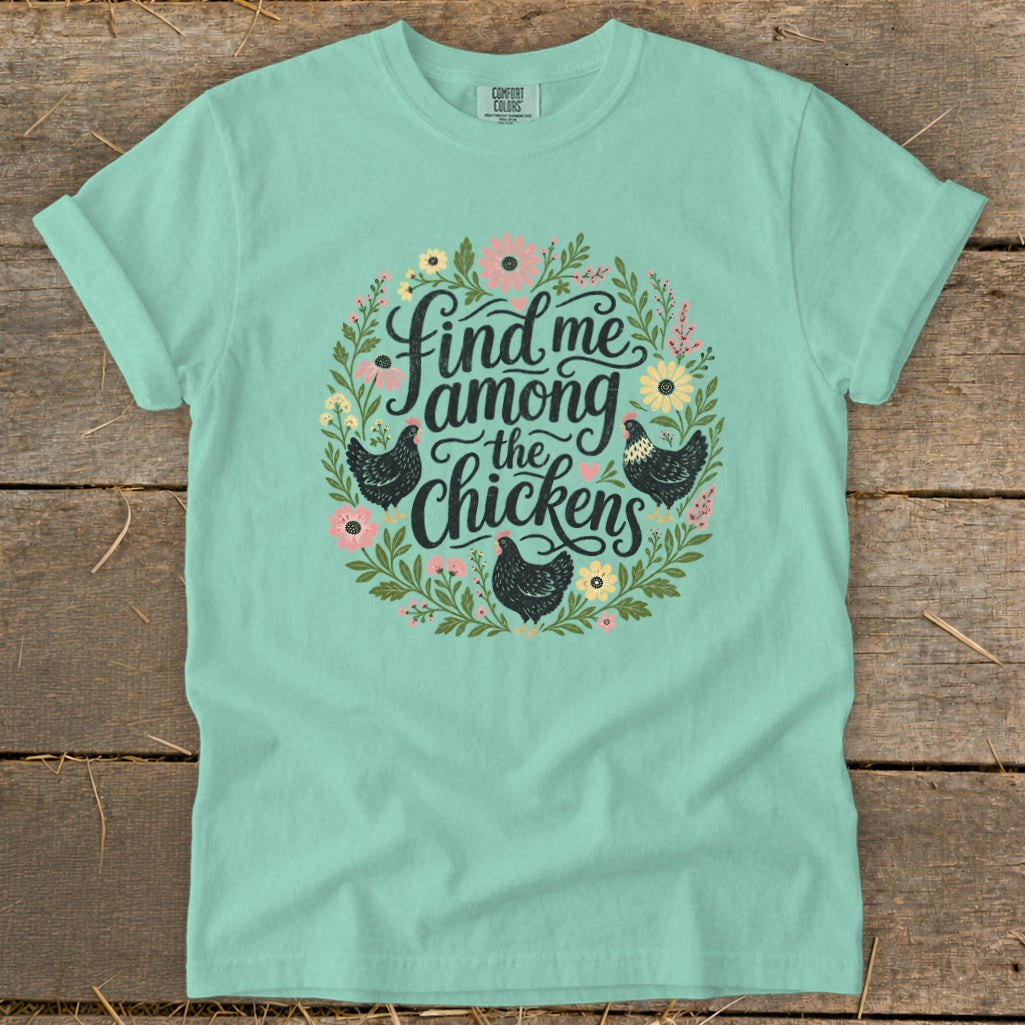 Light blue t-shirt with floral wreath and chickens graphic saying "Find me among the chickens".