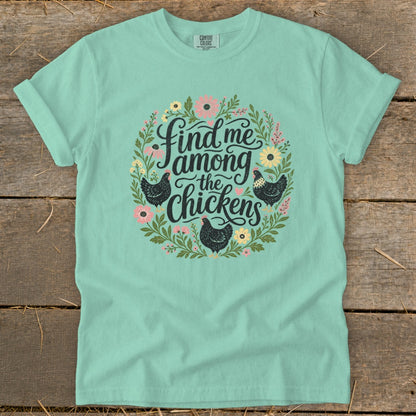 Light blue t-shirt with floral wreath and chickens graphic saying "Find me among the chickens".