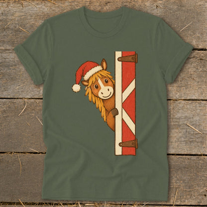 Horse wearing Santa hat peeking from behind a barn door.