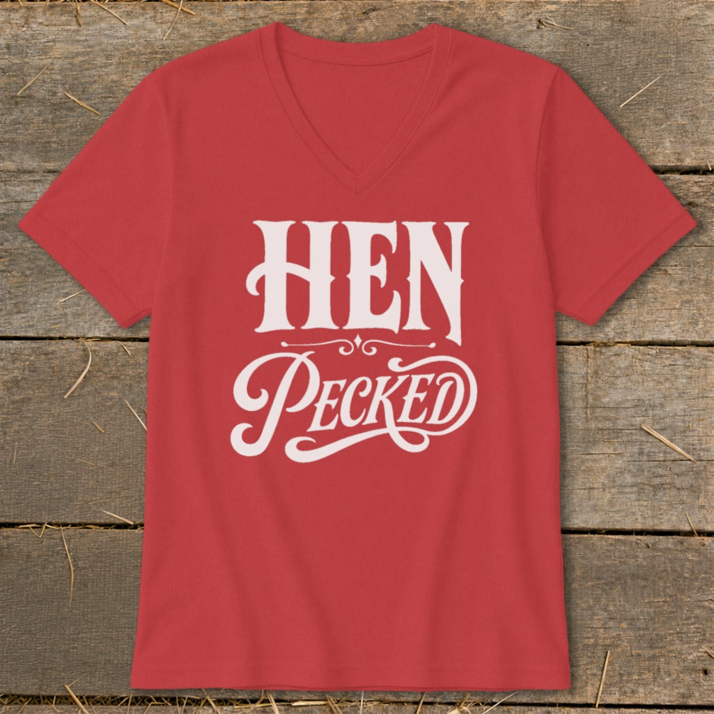 Red v-neck t-shirt with white "HEN Pecked" text and decorative swirls.