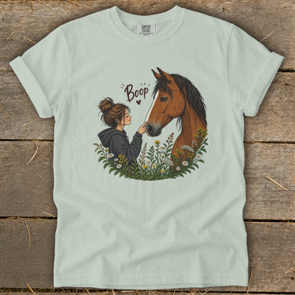 Girl touching horse's nose with "Boop" text above.