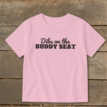 Pink t-shirt with "Dibs on the BUDDY SEAT" text.