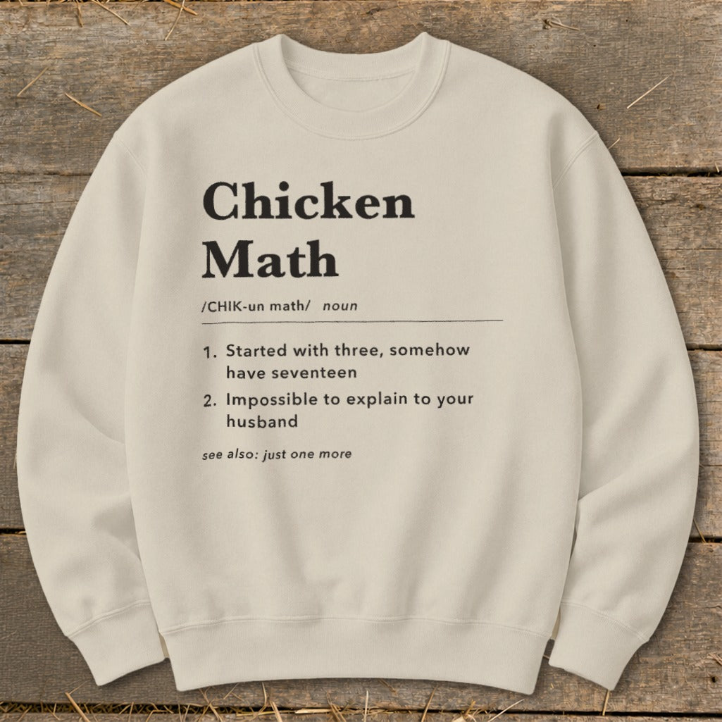 Cream sweatshirt with black text defining "Chicken Math" humorously.