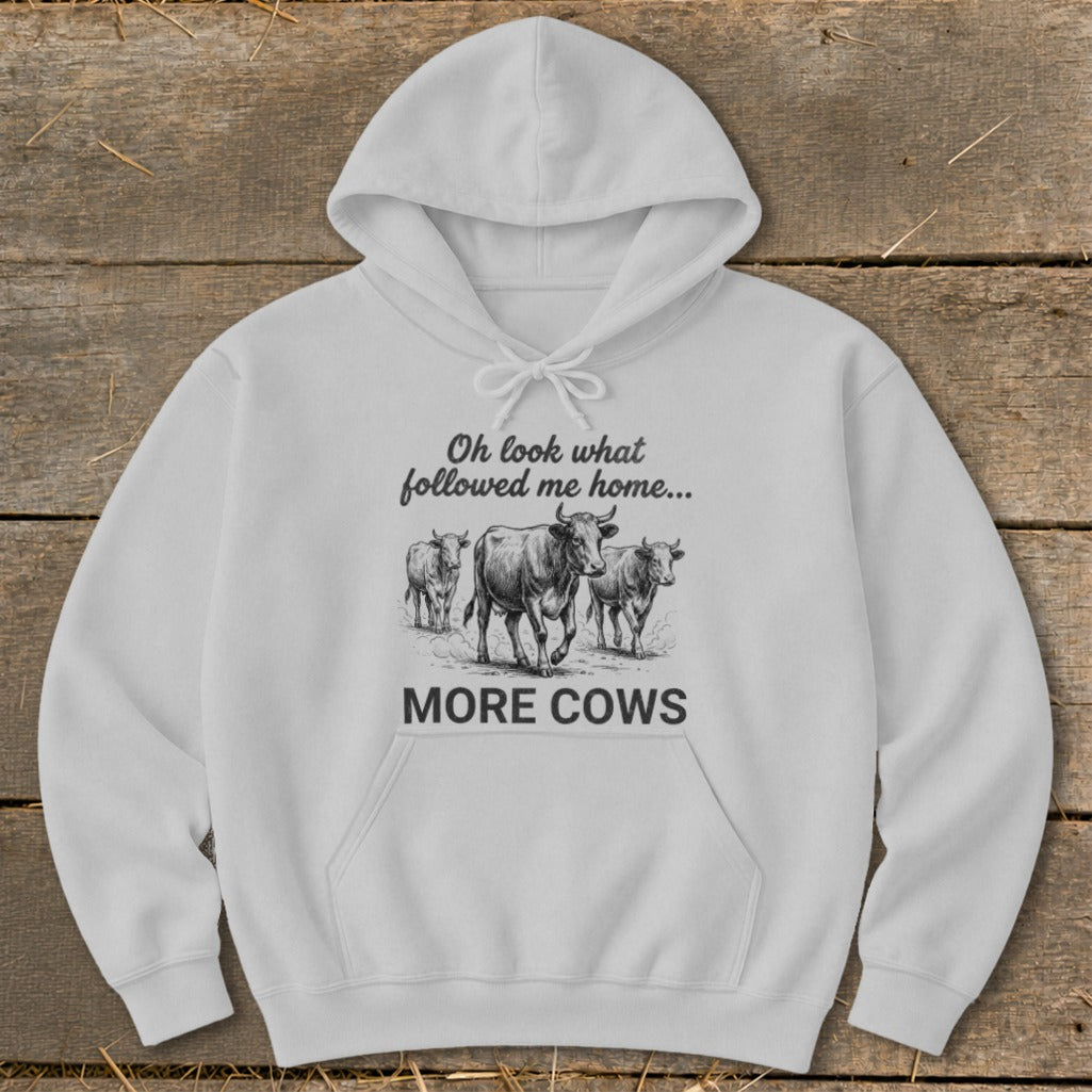 White hoodie with sketch of three cows and text "Oh look what followed me home... MORE COWS".