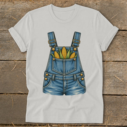 White t-shirt with a denim overalls graphic featuring corn cobs in the pocket.