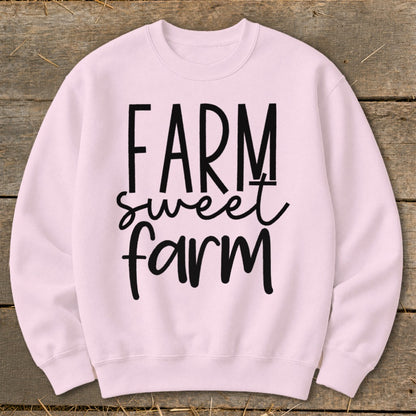 Light pink sweatshirt with "FARM sweet farm" text in black.