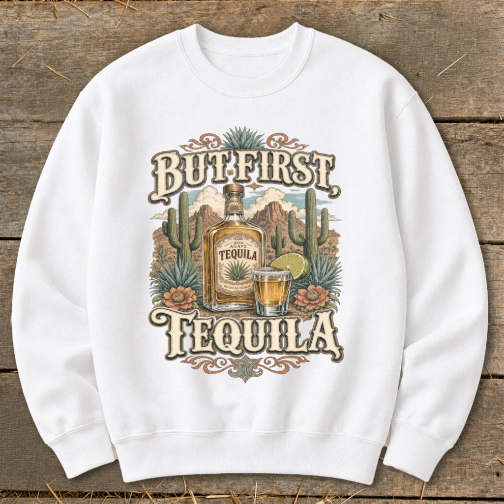 White sweatshirt with "But First Tequila" graphic featuring a tequila bottle and shot glass.