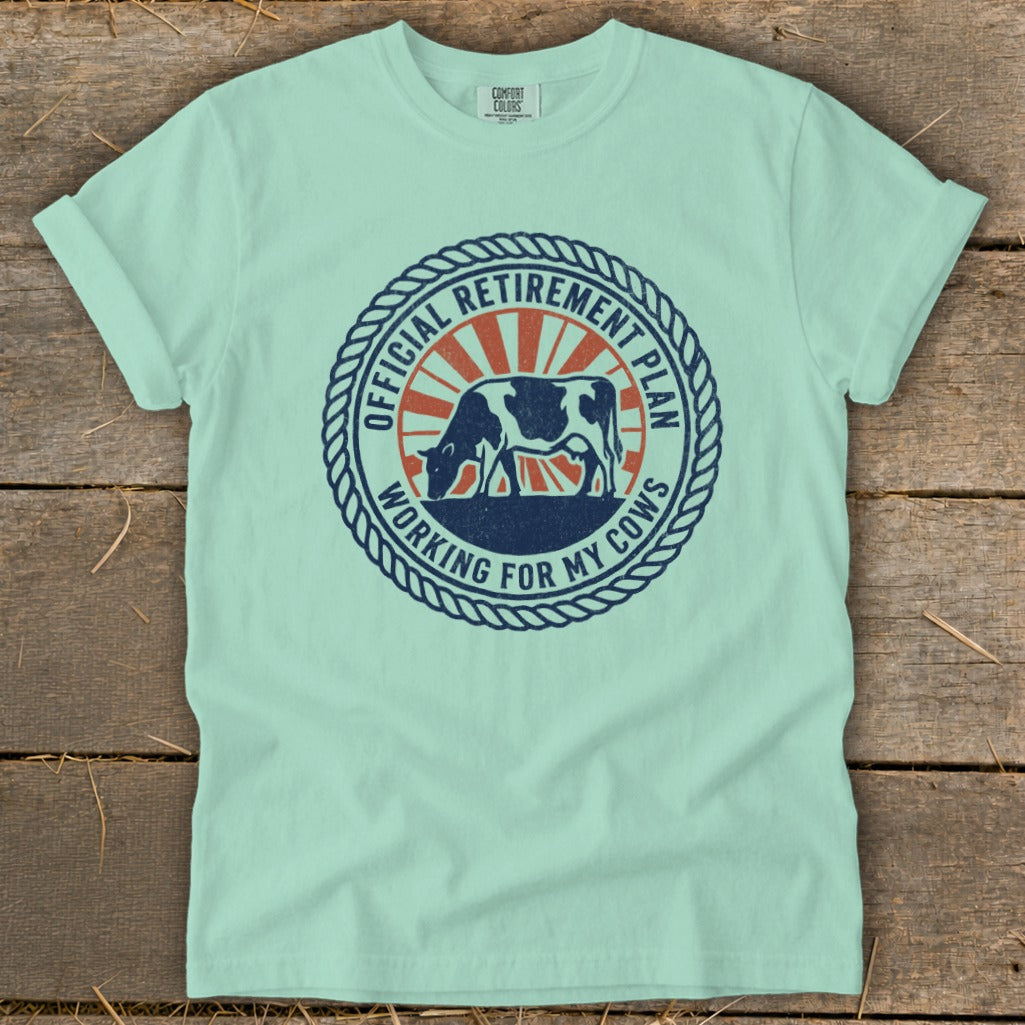 Mint t-shirt with a circular graphic of a cow and text "Official Retirement Plan Working for My Cows".