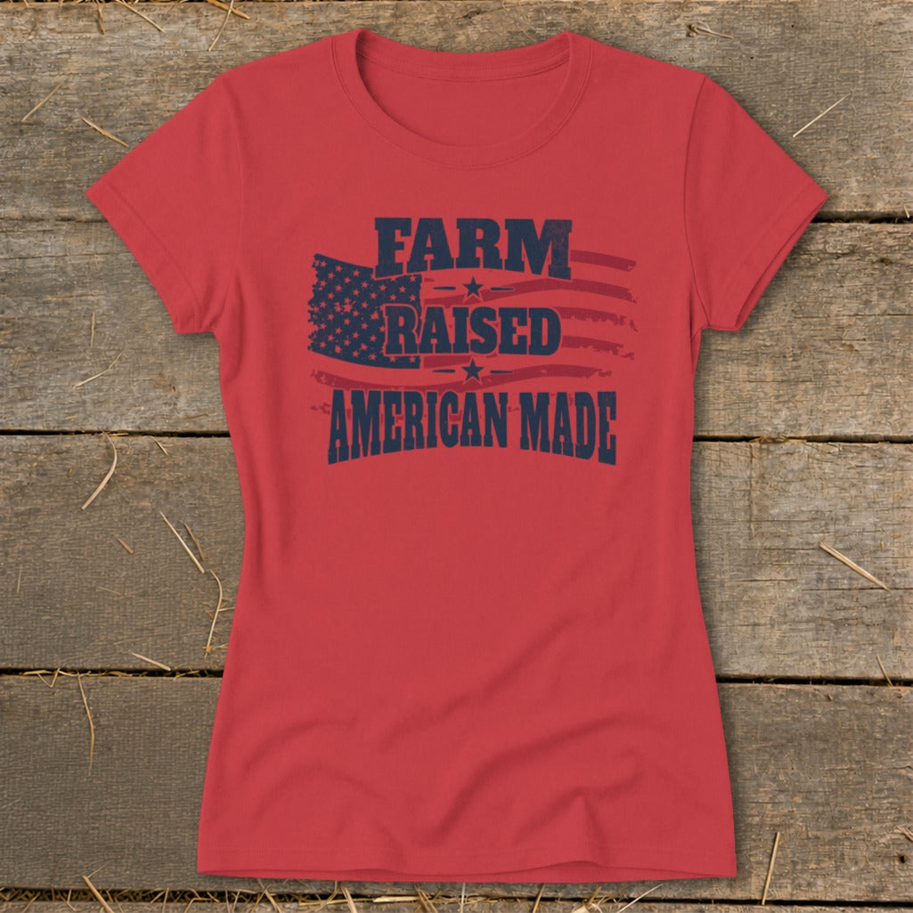 Red t-shirt with dark blue text "FARM RAISED AMERICAN MADE" and American flag graphic.