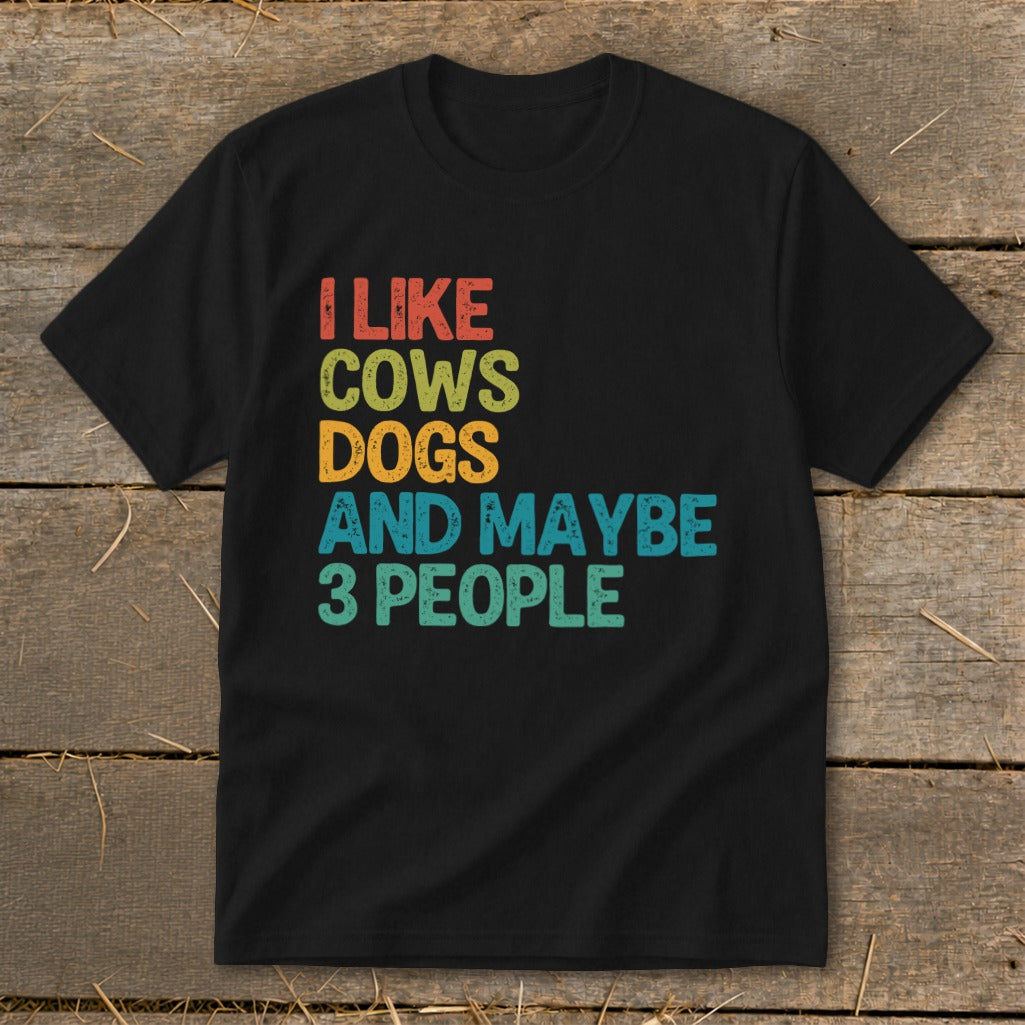 Black t-shirt with colorful text "I like cows dogs and maybe 3 people".