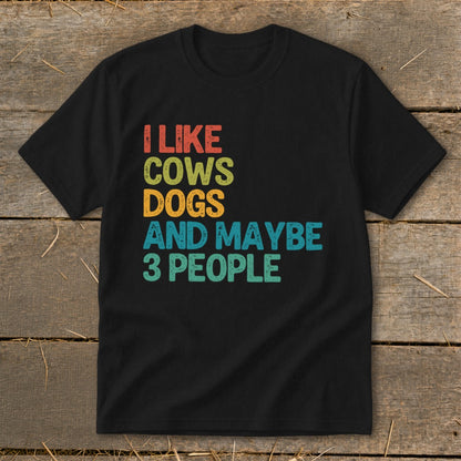 Black t-shirt with colorful text "I like cows dogs and maybe 3 people".