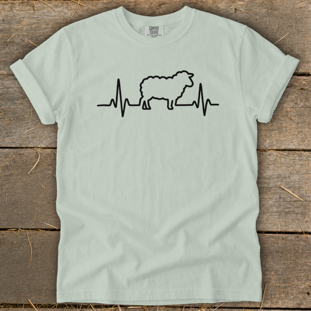 Light green short-sleeve t-shirt with a black graphic of a sheep integrated into a heartbeat line.