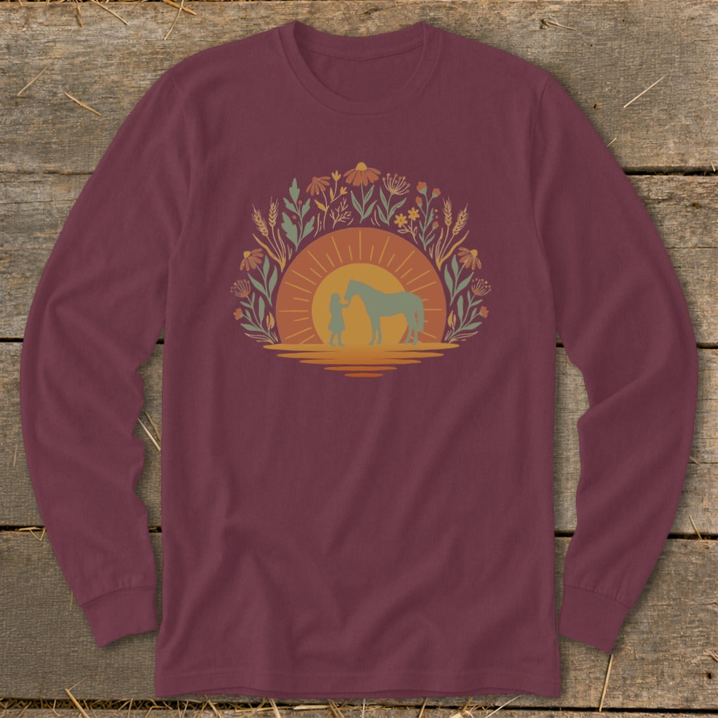 Maroon long sleeve shirt with a girl and horse silhouette against a sunset floral design.