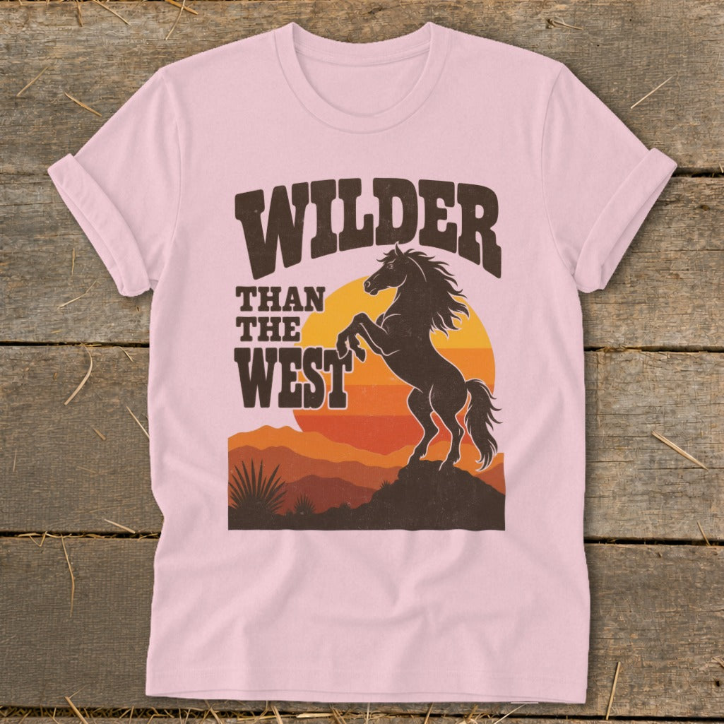 Pink t-shirt with "Wilder Than The West" and a rearing horse graphic.