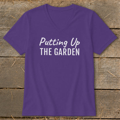 Purple v-neck t-shirt with white text "Putting Up THE GARDEN".