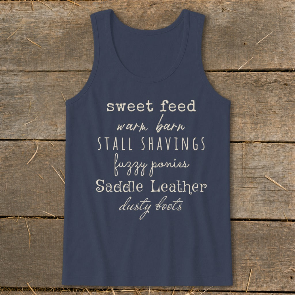 Navy tank top with text: sweet feed, warm barn, stall shavings, fuzzy ponies, saddle leather, dusty boots.