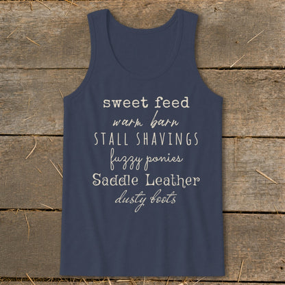 Navy tank top with text: sweet feed, warm barn, stall shavings, fuzzy ponies, saddle leather, dusty boots.