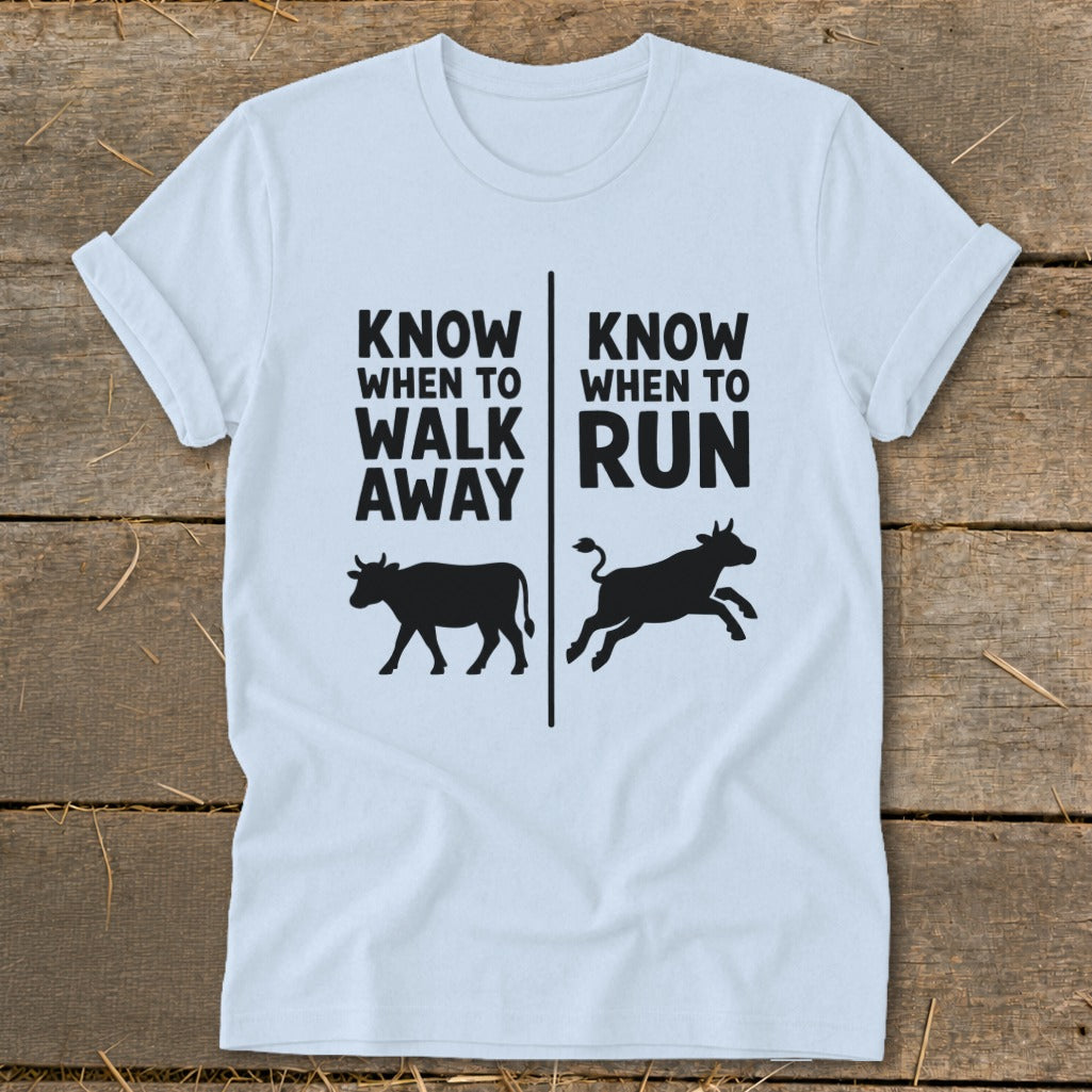 Light blue t-shirt with text "KNOW WHEN TO WALK AWAY" and "KNOW WHEN TO RUN" with cows.