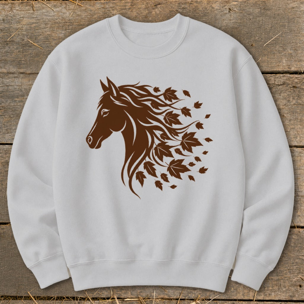 Brown horse head with flowing mane transitioning into autumn leaves on a white sweatshirt.
