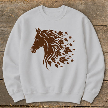 Brown horse head with flowing mane transitioning into autumn leaves on a white sweatshirt.