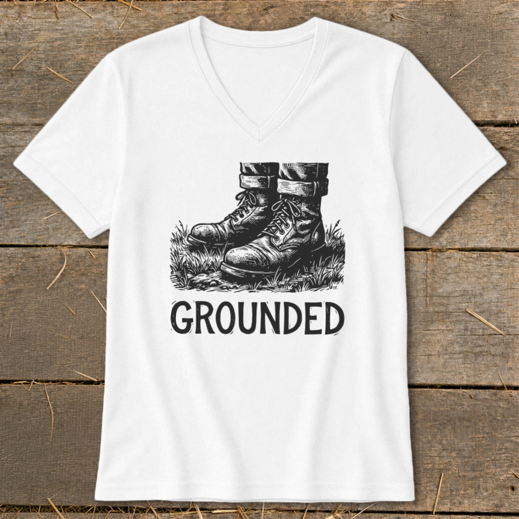 White t-shirt with sketch of boots on grass and the word "GROUNDED".