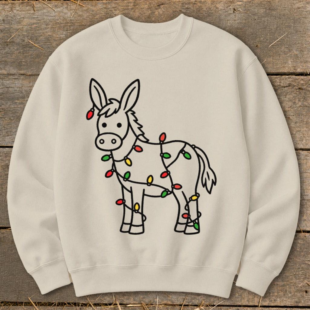 Cream sweatshirt with a cartoon donkey wrapped in colorful Christmas lights.