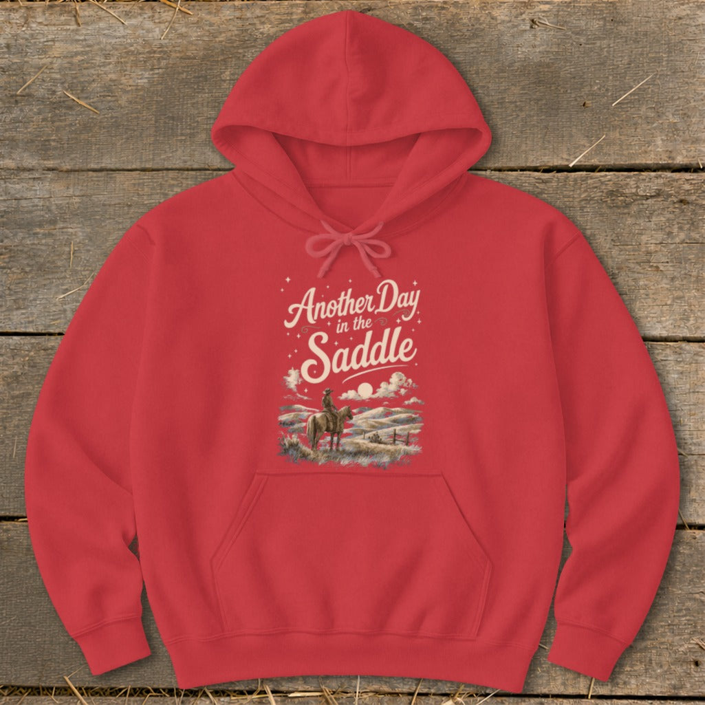 Red hoodie with "Another Day in the Saddle" graphic featuring a cowboy and a landscape.