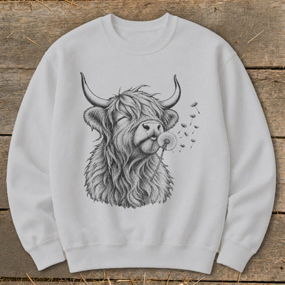 Crewneck sweatshirt with a black and white drawing of a Highland cow blowing on a dandelion.