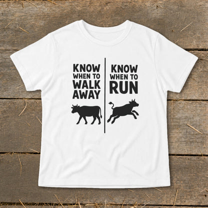 White t-shirt with black text and cow graphics, reading "Know When to Walk Away" and "Know When to Run".