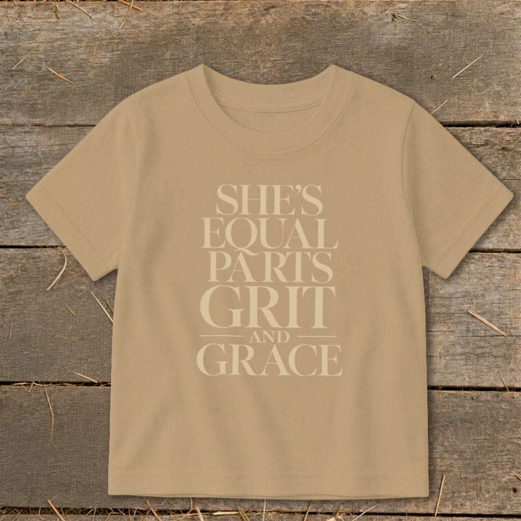 Tan t-shirt with text: She's Equal Parts Grit and Grace.