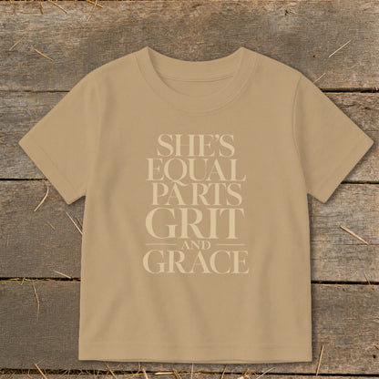Tan t-shirt with text: She's Equal Parts Grit and Grace.