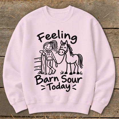 Pink sweatshirt with black text and line art of a girl and horse reading "Feeling Barn Sour Today".