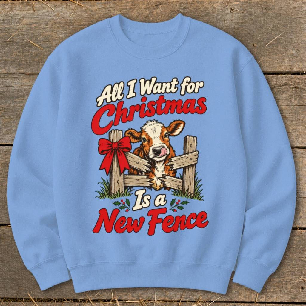 Blue sweatshirt with a cow peeking through a fence, "All I Want for Christmas Is a New Fence" text.