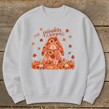 Floral bunny surrounded by pumpkins and autumn leaves with "pumpkin season" text.
