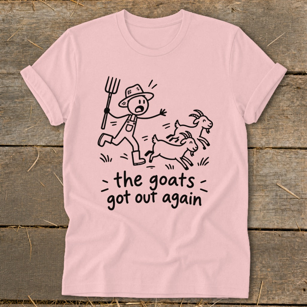Pink t-shirt with a stick figure farmer chasing three goats, text reads "the goats got out again".