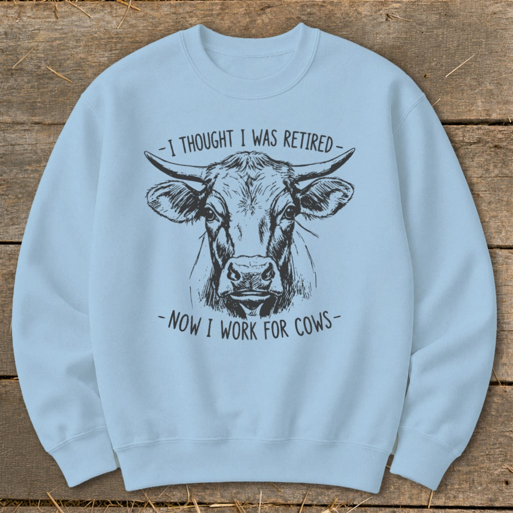 Light blue sweatshirt with a black ink drawing of a cow's head and text.