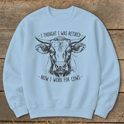 Light blue sweatshirt with a black ink drawing of a cow's head and text.