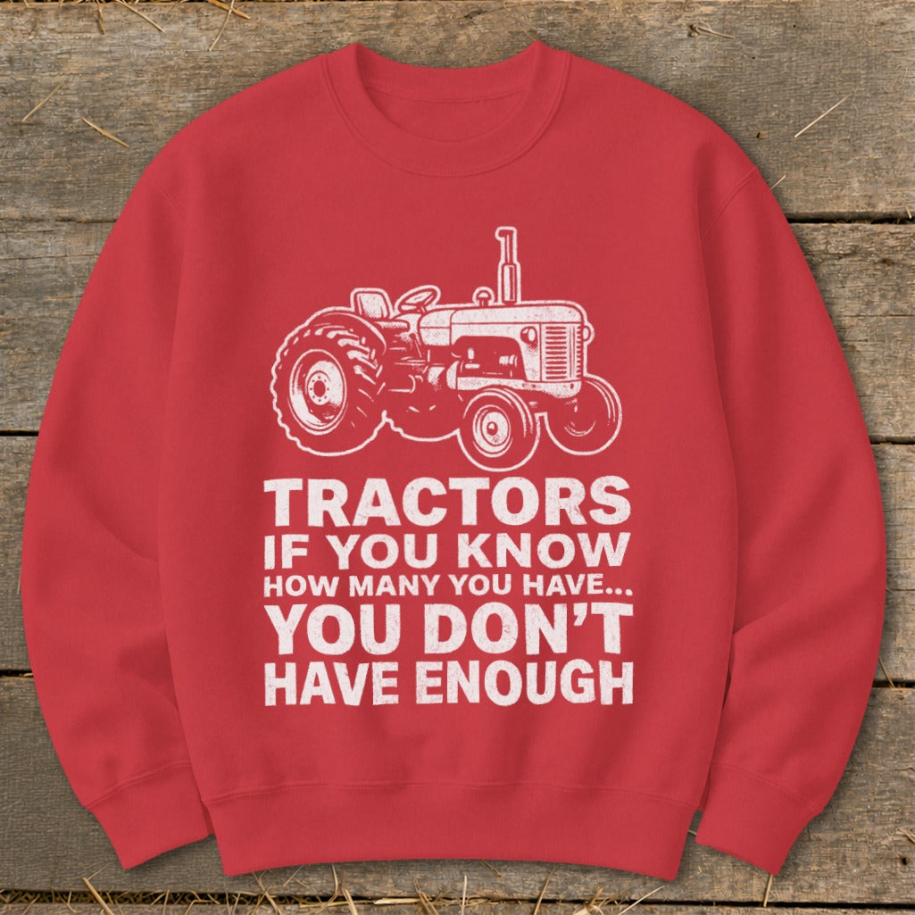 Red sweatshirt with white tractor graphic and text: "Tractors If You Know How Many You Have... You Don't Have Enough."