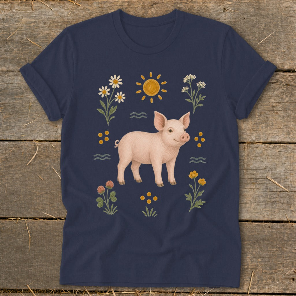 Navy t-shirt with a watercolor illustration of a piglet surrounded by flowers and a sun.