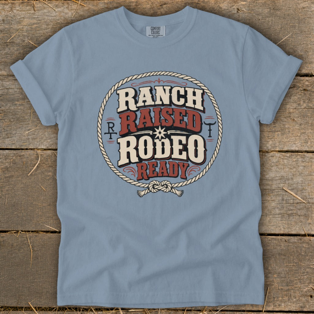 A light blue t-shirt with rolled sleeves features a circular graphic reading Ranch Raised Rodeo Ready.