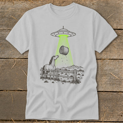 UFO beaming a hay bale down onto a surprised horse in a fenced pasture.