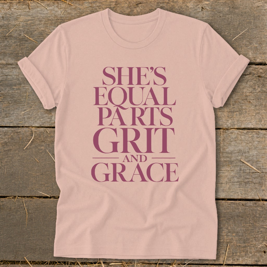 Pink t-shirt with "She's Equal Parts Grit and Grace" text in dark pink.